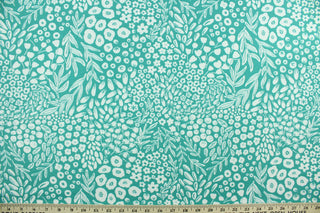 Krisa features a floral and leaf design in white against a blue/green background.  It is perfect for any project where the fabric will be exposed to the weather.  Able to resist stains and water, and has a rating of 15,000 double rubs, UV tested and can withstand 500 hours of direct sunlight  Uses include cushions, tablecloths, upholstery projects, decorative pillows and craft projects. This fabric has a slightly stiff feel but is easy to work with.  