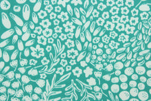 Load image into Gallery viewer, Krisa features a floral and leaf design in white against a blue/green background.  It is perfect for any project where the fabric will be exposed to the weather.  Able to resist stains and water, and has a rating of 15,000 double rubs, UV tested and can withstand 500 hours of direct sunlight  Uses include cushions, tablecloths, upholstery projects, decorative pillows and craft projects. This fabric has a slightly stiff feel but is easy to work with.  
