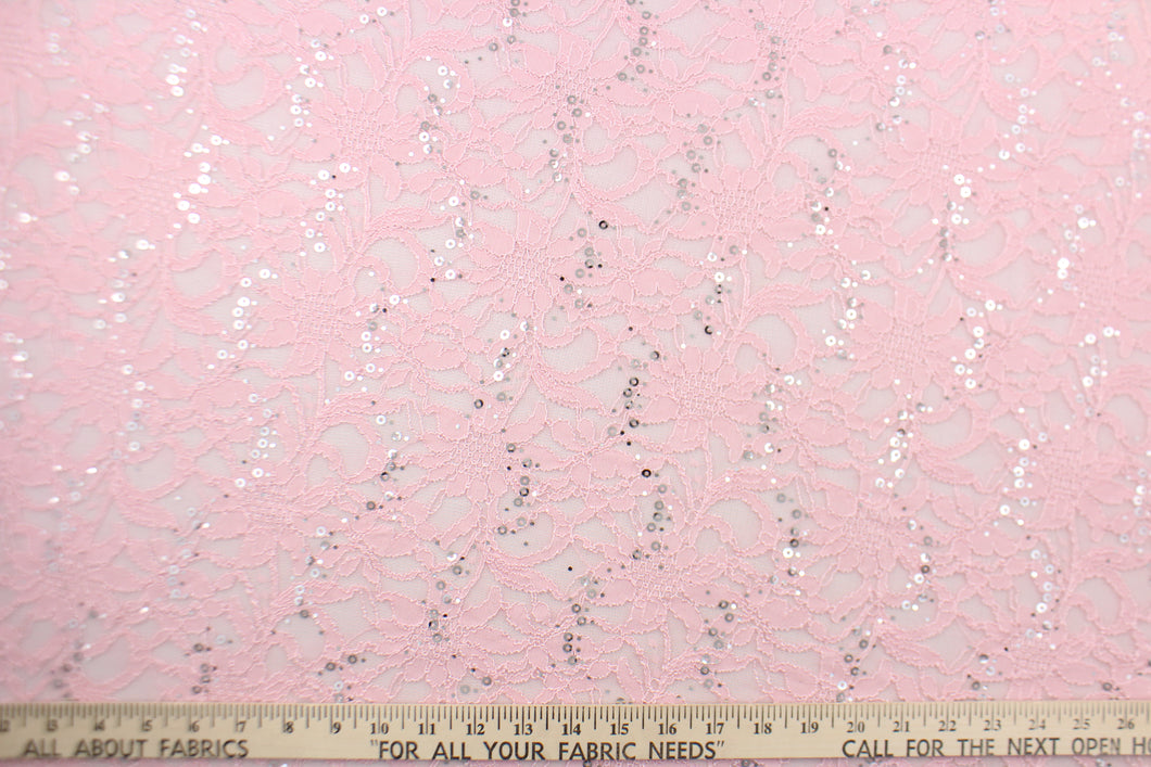  This lace features a floral sequin design in pink with a stretch. 