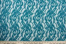Load image into Gallery viewer, This lace features a floral design in a teal blue with a stretch
