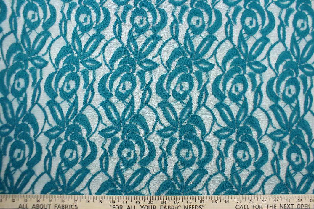 This lace features a floral design in a teal blue with a stretch