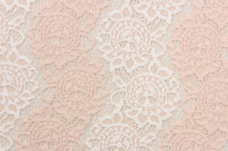 This lace features a floral design in a pale pink and white with a stretch.