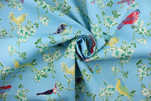 Load image into Gallery viewer, Tweet Toile is an outdoor fabric featuring various colored birds perched on flowering tree branches. 

