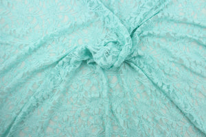 This lace features a floral design in a beautiful blue green with a stretch.