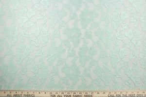 This lace features a floral design in a mint green with a stretch.