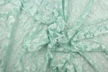 Load image into Gallery viewer, This lace features a floral design in a mint green with a stretch.
