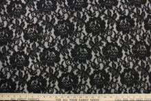 Load image into Gallery viewer, This lace features a floral sequin design in black with a stretch. 
