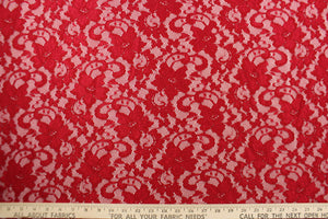 This lace features a floral design in a rich red with a stretch. 