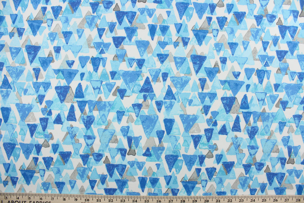  Reef Point features layered cascading triangles in shades of blue and gray against a white background.  It is perfect for any project where the fabric will be exposed to the weather.  Able to resist stains and water and can withstand 500 hours of direct sunlight.  Strong and durable with a rating of 51,000 double rubs.  Uses include cushions, tablecloths, upholstery projects, decorative pillows and craft projects. This fabric has a slightly stiff feel but is easy to work with.  