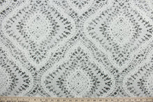 Load image into Gallery viewer, Curves Ahead features a diamond medallion design in gray and cream.   The versatile fabric is perfect for window accents (draperies, valances, curtains and swags) cornice boards, accent pillows, bedding, headboards, cushions, ottomans, slipcovers and upholstery.  It has a soft workable feel yet is stable and durable with 51,000 double rubs.
