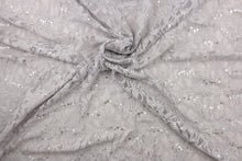 Load image into Gallery viewer, This lace features a floral sequin design in a silver or gray with a stretch. 
