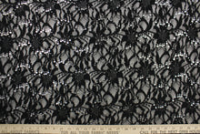 Load image into Gallery viewer, This lace features a floral with silver sequin design in a black with a stretch
