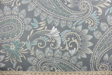 Load image into Gallery viewer, This Solarium outdoor decorative print features a large paisley design in white, turquoise and khaki against a gray background.  This versatile, long-lasting fabric can withstand up to 500 hours of sunlight, water and stain resistant and has 10,000 double rubs.  It is perfect for lounge cushions, pool furniture, tablecloths, decorative pillows and upholstery projects.  This fabric has a slightly stiff feel but is easy to work
