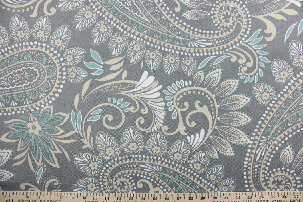 This Solarium outdoor decorative print features a large paisley design in white, turquoise and khaki against a gray background.  This versatile, long-lasting fabric can withstand up to 500 hours of sunlight, water and stain resistant and has 10,000 double rubs.  It is perfect for lounge cushions, pool furniture, tablecloths, decorative pillows and upholstery projects.  This fabric has a slightly stiff feel but is easy to work