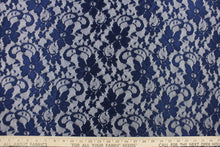 Load image into Gallery viewer,  This lace features a floral design in a rich navy blue with a stretch.

