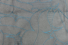Load image into Gallery viewer, This lace with a unique design in a blue color against a black background . 
