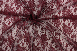  This lace features a floral design in a burgundy with a stretch.