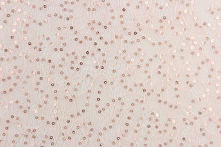 This lace features a sequin floral design in a  light pink with a stretch. 