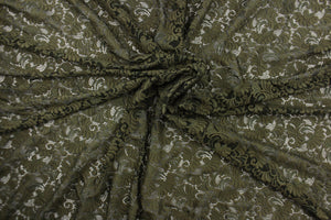 This lace features a ornamental design in a rich army green with a stretch. 