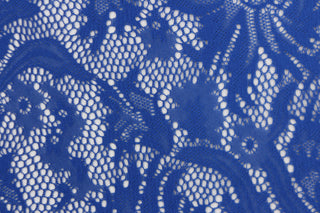 This lace features a floral design in a rich blue with a stretch.