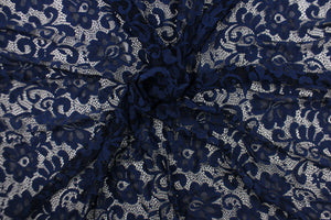 This lace features a floral design in a rich navy blue with a stretch. 