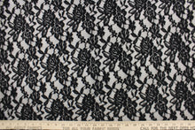 Load image into Gallery viewer, This lace features a floral design in black with a stretch. 
