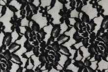 Load image into Gallery viewer, This lace features a floral design in black with a stretch. 
