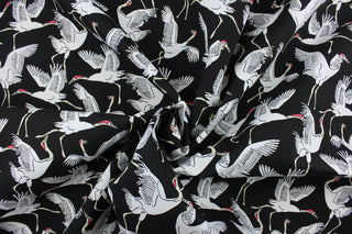 This screen printed fabric features cranes in white against an ebony background.  Perfect for any project where the fabric will be exposed to the weather.  It is fade resistant and features a water repellant finish with a rating of 33,000 double rubs.  Uses include cushions, tablecloths, upholstery projects, decorative pillows and craft projects. This fabric has a slightly stiff feel but is easy to work with.  