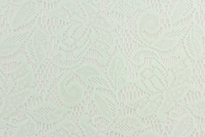  This lace features a floral design in a mint green with a stretch.