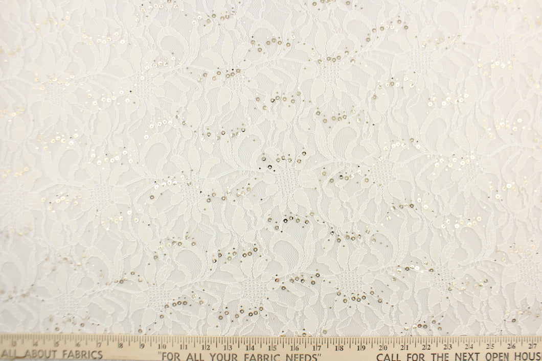 This lace features a floral sequin design in a white with a stretch.