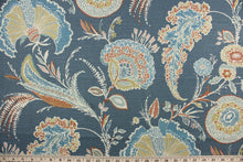 Load image into Gallery viewer, Malaya features a large scale floral design in shades of blue, cream, rust and dark beige.  It can be used for several different statement projects including window accents (drapery, curtains and swags), decorative pillows, hand bags, bed skirts, duvet covers, upholstery and craft projects.  It has a soft workable feel yet is stable and durable with 15,000 double rubs.
