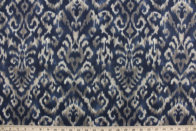 Komodo features a beautiful ikat design in navy blue and brown.  The versatile fabric is perfect for window accents (draperies, valances, curtains and swags) cornice boards, accent pillows, bedding, headboards, cushions, ottomans, slipcovers and upholstery.  It has a soft workable feel yet is stable and durable with 50,000 double rubs.