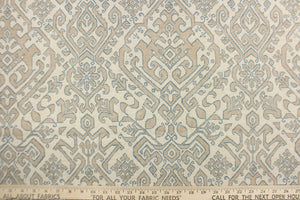 This fabric features an Aztec design in blue, taupe and natural .