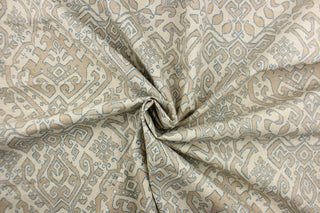 This fabric features an Aztec design in blue, taupe and natural .