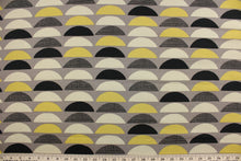 Load image into Gallery viewer,  This fabric features various large scale half-circles screen printed on 100% cotton duck.  Colors included are black, yellow gold and beige on a taupe background.  The multi use fabric is perfect for window treatments, decorative pillows, custom cushions, bedding, light duty upholstery applications and almost any craft project.  This fabric has a soft workable feel yet is stable and durable with 50,000 double rubs.
