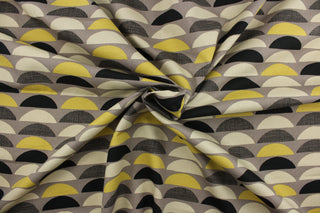 This fabric features various large scale half-circles screen printed on 100% cotton duck.  Colors included are black, yellow gold and beige on a taupe background.  The multi use fabric is perfect for window treatments, decorative pillows, custom cushions, bedding, light duty upholstery applications and almost any craft project.  This fabric has a soft workable feel yet is stable and durable with 50,000 double rubs.
