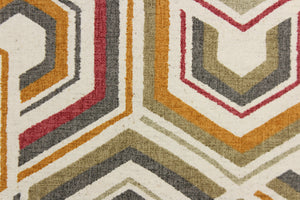  This fabric features a contemporary geometric design in taupe, beige, gray, orange, red, and off white. 