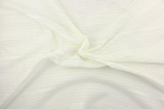 This sheer fabric features a stripe design in a rich cream.