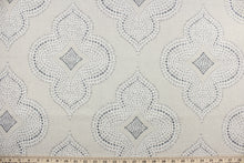 Load image into Gallery viewer, This fabric features a fun geometric print design.  The versatile fabric is perfect for window accents (draperies, valances, curtains and swags) cornice boards, accent pillows, bedding, headboards, cushions, ottomans, slipcovers and upholstery.  It has a soft workable feel yet is stable and durable with 50,000 double rubs.  Colors include grey, crème, putty and sand beige.
