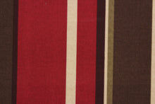 Load image into Gallery viewer, Monserrat is an outdoor fabric featuring multi width stripes in shades of brown, beige and dark red.  It is perfect for outdoor settings or indoors in a sunny room.  Solarium fabrics can withstand up to 500 hours of sunlight, water and stain resistant and has a rating of 10,000 double rubs.  Uses include toss pillows, cushions, upholstery, pool furniture, tote bags and more.
