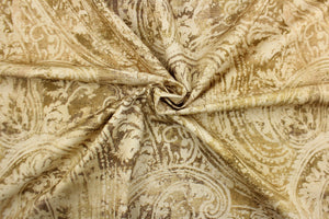 This fabric features a paisley design in brown tones with hints of green .