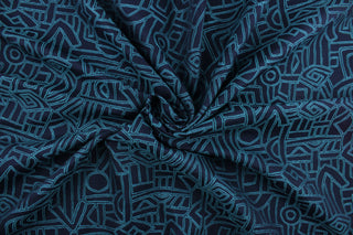 Lagos is a multi use jacquard fabric featuring a geometric design in teal against a navy blue background.  It is durable and would be great for upholstery, bedding, cornice boards, accent pillows and window treatments.