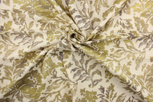 Load image into Gallery viewer, This fabric features a metallic threaded floral design in gold with black and gray tones .

