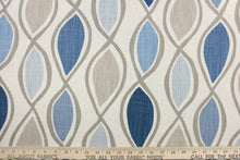 Load image into Gallery viewer, This fabric features a geometric design in blue, gray, taupe, and natural. 
