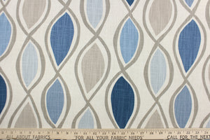 This fabric features a geometric design in blue, gray, taupe, and natural. 