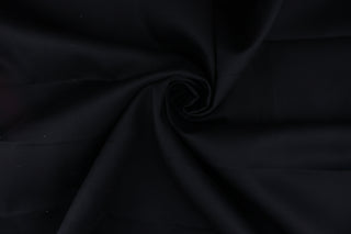 Nightfall in Black is a versatile fabric with a reliable twill weave.  Its solid black color gives it high durability and comfort, while the relaxed drape and shape retention makes it ideal for apparel, slipcovers, and curtains.