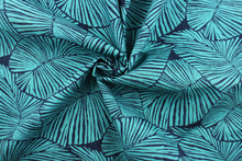 Load image into Gallery viewer, This Solarium outdoor decorative print features a large leaf design in turquoise and navy blue.  This versatile, long-lasting fabric can withstand up to 500 hours of sunlight, water and stain resistant and has 10,000 double rubs.  It is perfect for lounge cushions, pool furniture, tablecloths, decorative pillows and upholstery projects.  This fabric has a slightly stiff feel but is easy to work with.  
