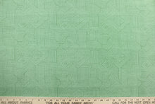Load image into Gallery viewer, This Solarium outdoor decorative print features a geometric design in green.  This versatile, long-lasting fabric can withstand up to 500 hours of sunlight, water and stain resistant and has 10,000 double rubs.  It is perfect for lounge cushions, pool furniture, tablecloths, decorative pillows and upholstery projects.  This fabric has a slightly stiff feel but is easy to work with.  
