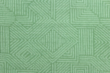 Load image into Gallery viewer, This Solarium outdoor decorative print features a geometric design in green.  This versatile, long-lasting fabric can withstand up to 500 hours of sunlight, water and stain resistant and has 10,000 double rubs.  It is perfect for lounge cushions, pool furniture, tablecloths, decorative pillows and upholstery projects.  This fabric has a slightly stiff feel but easy to work with.

