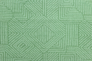 This Solarium outdoor decorative print features a geometric design in green.  This versatile, long-lasting fabric can withstand up to 500 hours of sunlight, water and stain resistant and has 10,000 double rubs.  It is perfect for lounge cushions, pool furniture, tablecloths, decorative pillows and upholstery projects.  This fabric has a slightly stiff feel but easy to work with.
